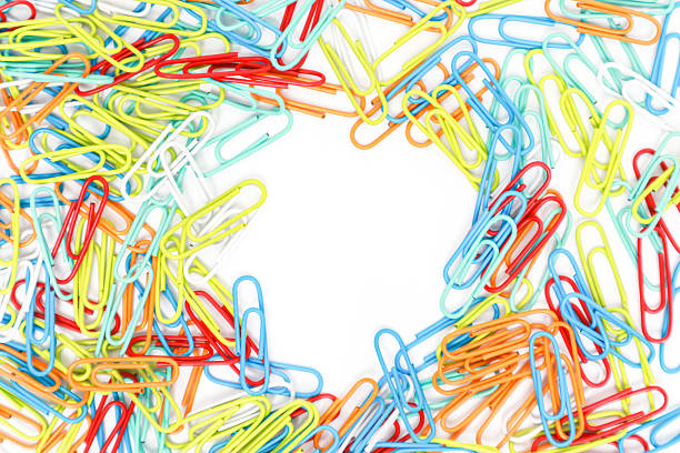 A vibrant array of colorful paper clips encircling a blank white space ready for text