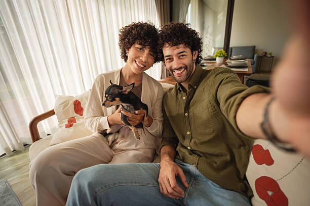 istock Couple taking selfie with dog at home 2223883029