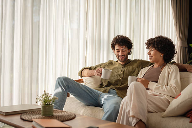 istock Happy couple relaxing on sofa with coffee at home 2223883059