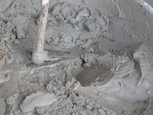 istock Mortar cement with hoe in tray as grey texture background for industry construction concept. 2223883744