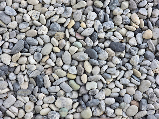 istock Smooth gray pebbles create natural texture, perfect for landscaping or decorative purposes. variety in shape and color adds visual interest to any outdoor space 2223884639