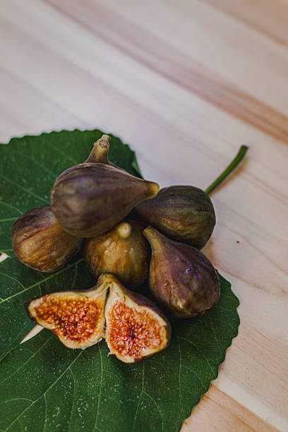 istock Juicy figs in a ceramic bowl on a wooden table - still life with natural light 2223888529