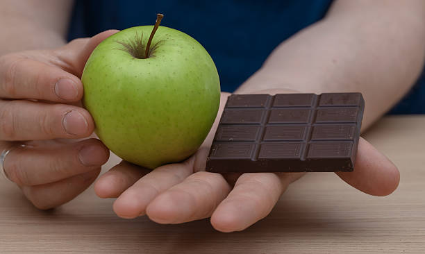 istock Healthy eating, good choices, apple or dark chocolate 2223889330