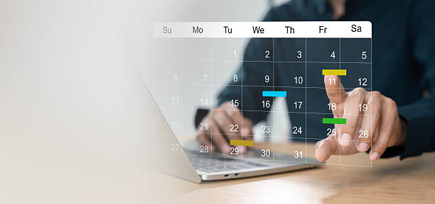 istock Businessman manages time for effective work. Calendar on the virtual screen interface, Businessman paste Post-it on important days on the calendar Important appointment dates 2223890737