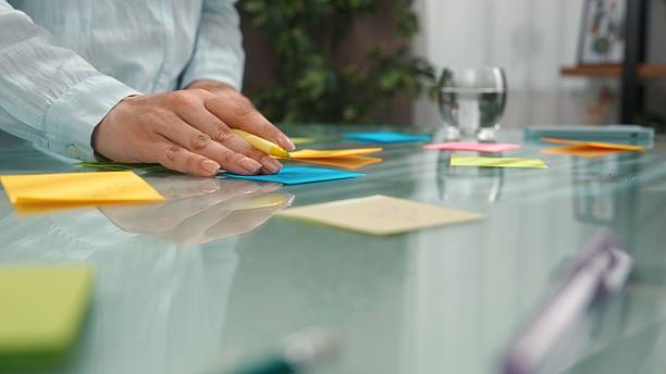 istock Organizing Ideas with Colorful Sticky Notes on Glass Surface 2223893074