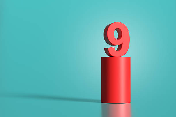 istock Red number nine standing on red cylinder on turquoise background 2223893180
