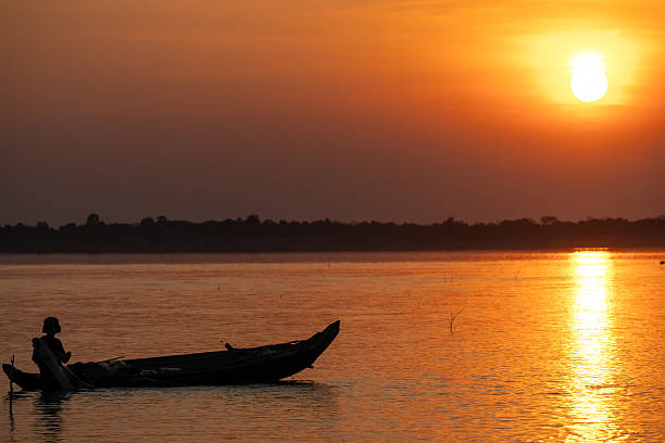 istock Canoe Silhouetted at Sunset Over River 2223893211