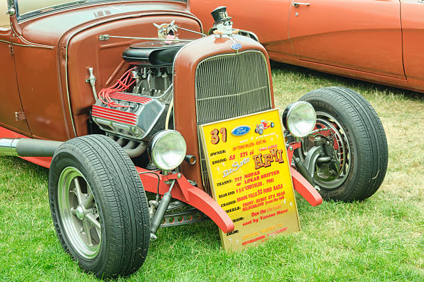 Buenos Aires, Argentina - Jul 9, 2025: Old yellow flame paint 1920s Ford model T hot rod at a classic car show in the street in front of a park.