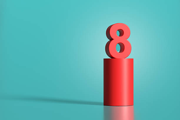 istock Red number eight standing on red cylinder on turquoise background 2223893368