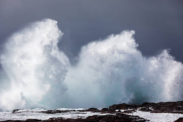 istock A giant ocean wave breaks onto a rocky headland, exploding into a wall of white water during a coastal storm swell. 2223894255