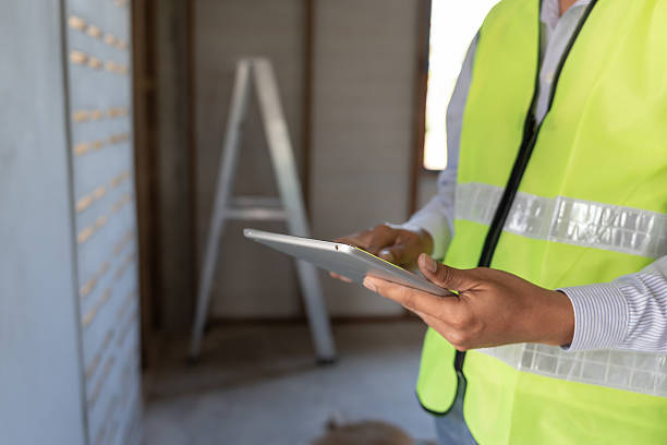 istock inspector or engineer is inspecting construction and quality assurance new house using a tablet. Engineers or architects or contactor work to build the house before handing it over to the homeowner 2223894777