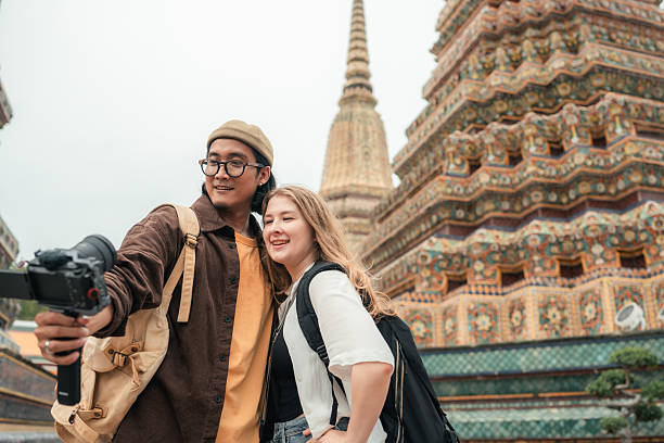 istock Influencer Couple Filming a Vlog While Exploring a Famous Temple Together 2223895364