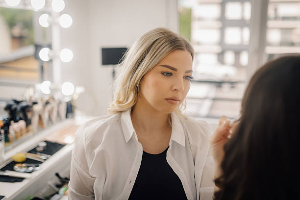 istock Professional makeup artist applying makeup to client in salon 2223895457