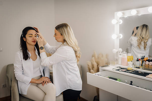 istock Makeup artist applying makeup on client's face in beauty salon 2223896071