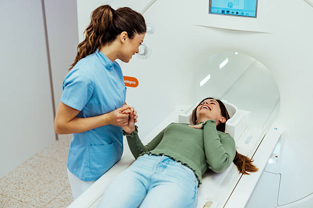 istock Friendly Nurse Assisting Patient During Advanced Medical Imaging Procedure 2223898335