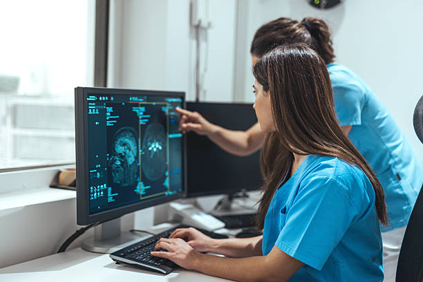 istock Medical Professionals Reviewing Brain Scans on Computer Screens 2223899467