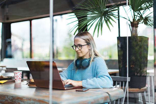 istock Mid adult woman working using laptop from cafe 2223900099