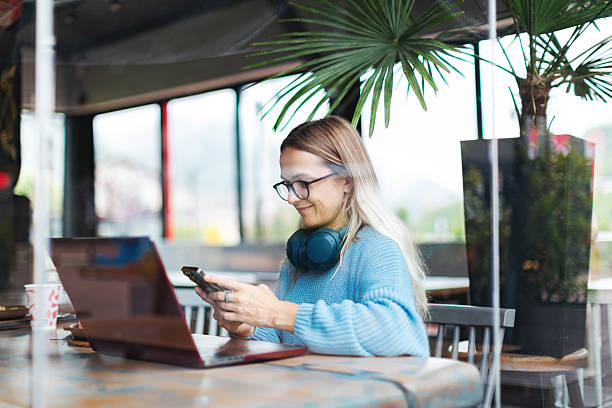 istock Mid adult woman working using laptop from cafe 2223900100