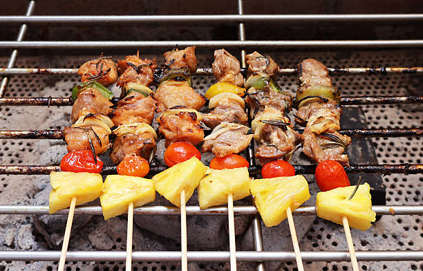 Row of Barbecue Being Grilled on a Charcoal Stove