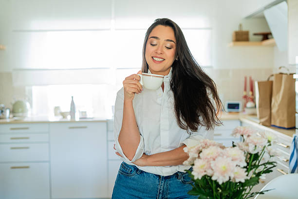 istock Young woman drinking hot coffee at home in the kitchen. 2223901955