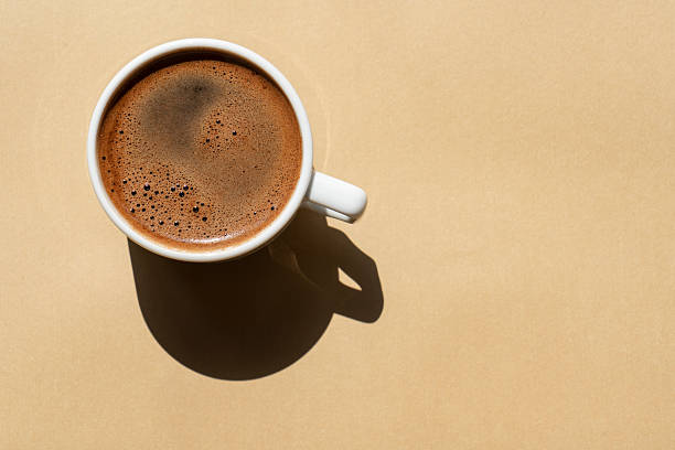 Directly Above View Of Coffee In Cup On Brown Background