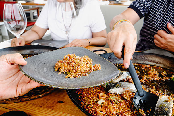 istock serving seafood rice from a paella pan 2223903479