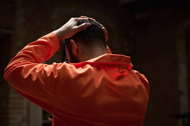 istock Young Caucasian Man Sitting in Group Therapy Session in Prison 2223904036