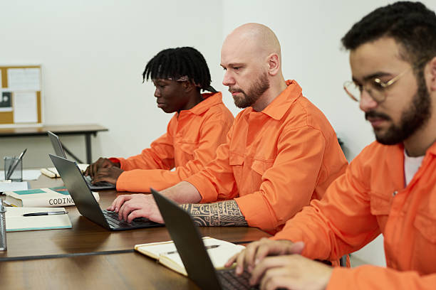 istock Multiethnic Young Adult Men Studying on Laptops during Prison Education Program 2223904612