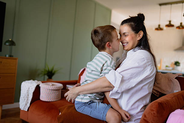 istock Mother and Son Bonding on Couch in Cozy Home Setting 2223905735