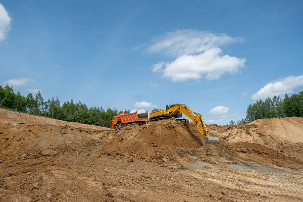 istock A caterpillar tractor works with a bucket in a sand pit. Sand mining 2223906603