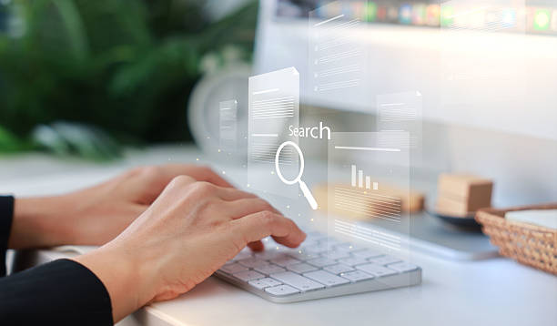 istock Hands typing on a white keyboard with search bar overlay, representing internet browsing, SEO, online research, digital marketing, communication, data input, coding and information search concept. 2223907790