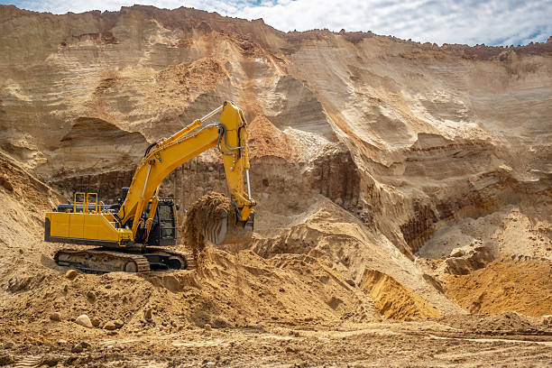 istock A caterpillar tractor works with a bucket in a sand pit. Sand mining 2223907893