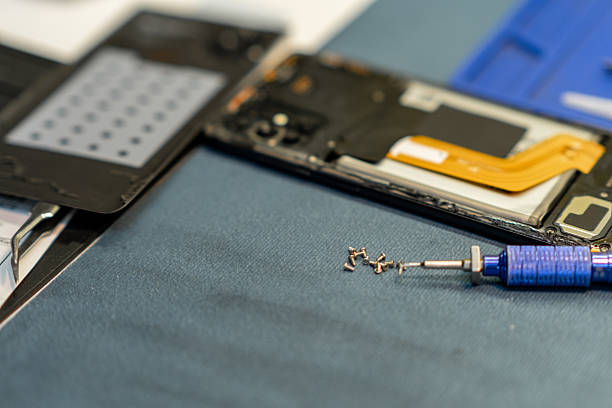 istock Professional Phone Repair With Tools and Components Laid out on a Workbench in a Workshop 2223910478