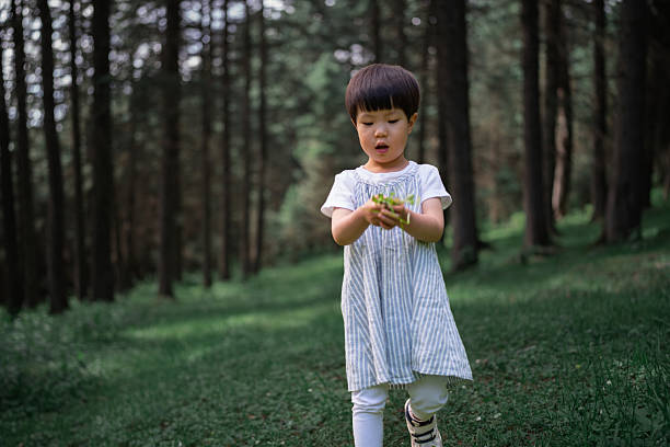Cute little girl playing in the forest