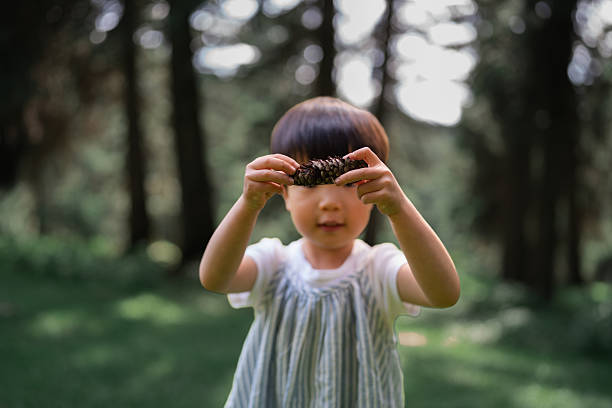 Cute little girl playing in the forest
