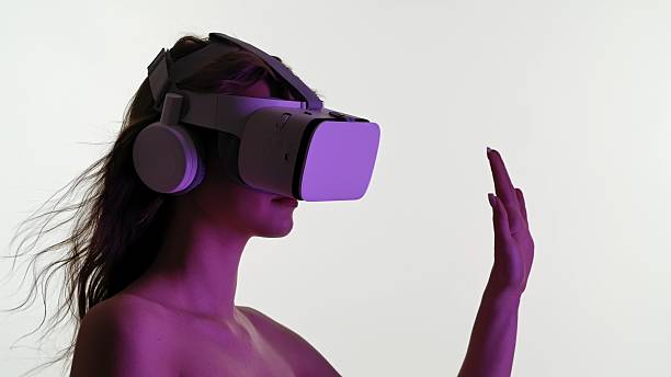istock Woman Experiencing Immersive Virtual Reality with Headset 2223913433