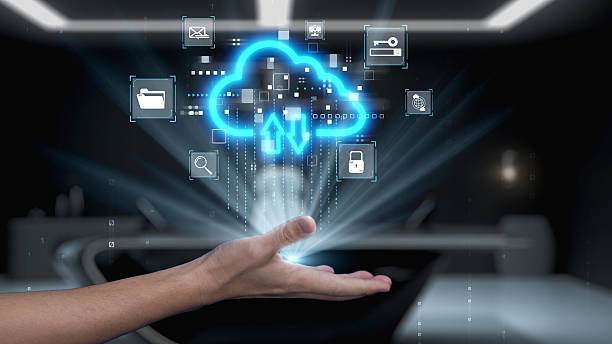 istock Futuristic hand holding glowing cloud icons, symbolizing data transfer, cloud storage technology, digital interface, connectivity and modern innovation in business. Auvana 2223913563