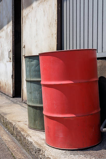 istock Two Metal Drums Outside a Warehouse on a Sunny Day 2223920635