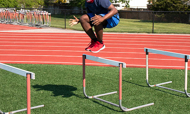 istock Athlete Jumps Over Hurdles on Training Track During Sunny Afternoon 2223921085