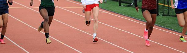 istock Five High School Girls Sprinting on a Track During a Competitive Race 2223921107