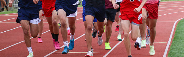 istock High School Boys Sprinting During Track Competition on Running Track 2223921125