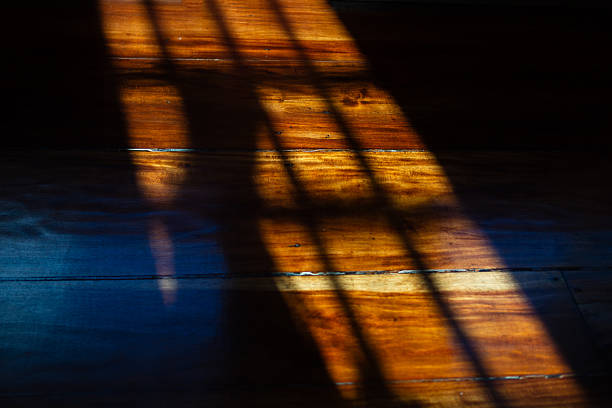 istock shadow cast on a wooden floor coming from a window. Texture 2223921731