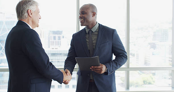 istock Networking, welcome and shaking hands with business men together with document for event. Greeting, partnership and handshake with employee for introduction to corporate seminar, office or workshop 2223922263