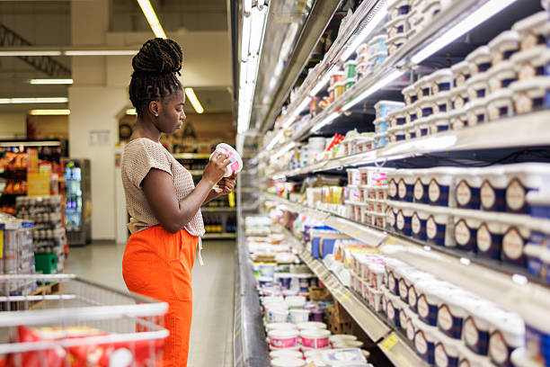 istock Female Customer Comparing Prices in Supermarket 2223923191