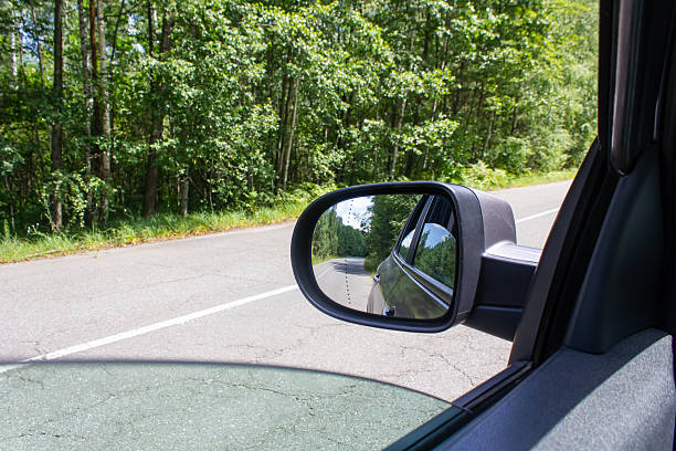 istock road reflected in car mirror close-up 2223925906