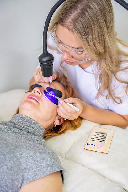 istock Eyelash extension procedure using ultraviolet lamp in modern beauty salon. Innovative lash enhancement technology with precise application technique. 2223926832