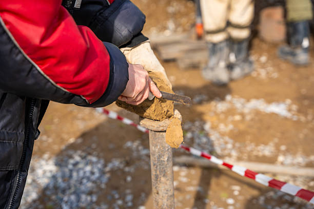 istock Man cutting and cleaning soil sample for laboratory analysis. Preparation of core material for geotechnical testing and scientific evaluatio 2223929188