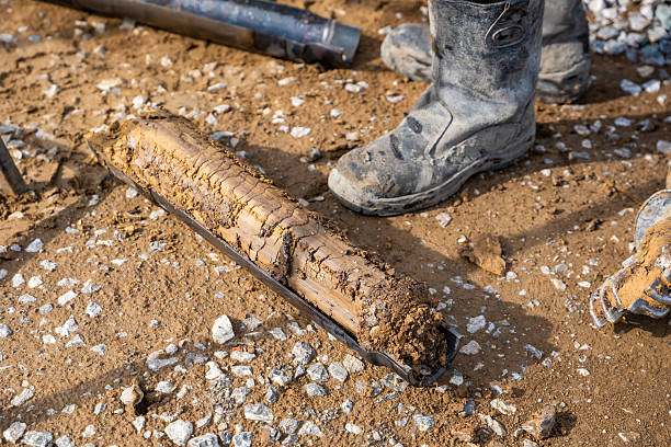 istock Fresh soil core sample placed on the ground after drilling. Subsurface material collected for geotechnical testing and laboratory analysis 2223929199