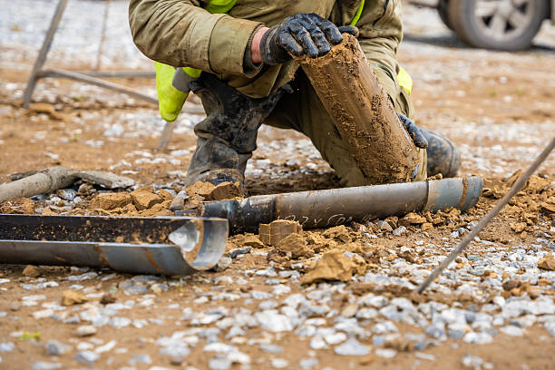 istock Man cutting and cleaning soil sample for laboratory analysis. Preparation of core material for geotechnical testing and scientific evaluatio 2223929204