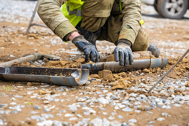 istock Man cutting and cleaning soil sample for laboratory analysis. Preparation of core material for geotechnical testing and scientific evaluatio 2223929211